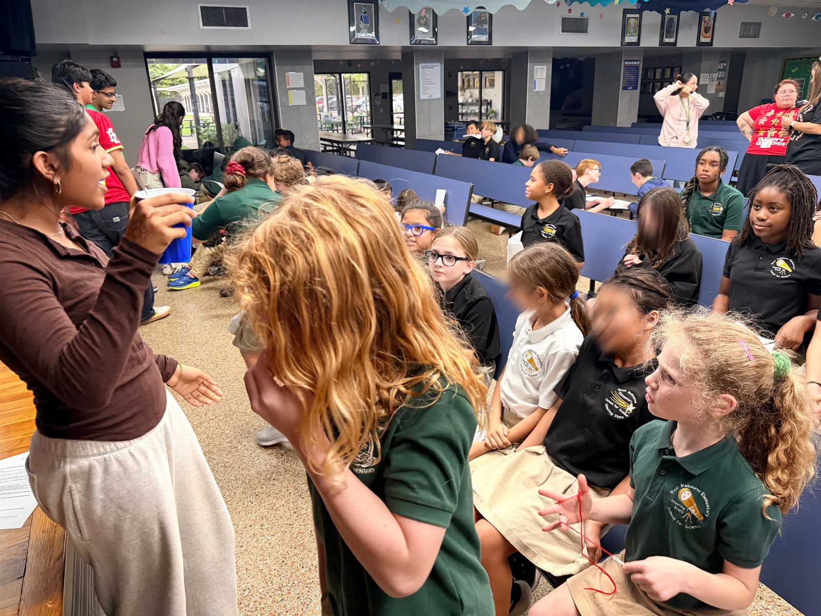 Brevard students speaking with younger students during a lagoon awareness activity